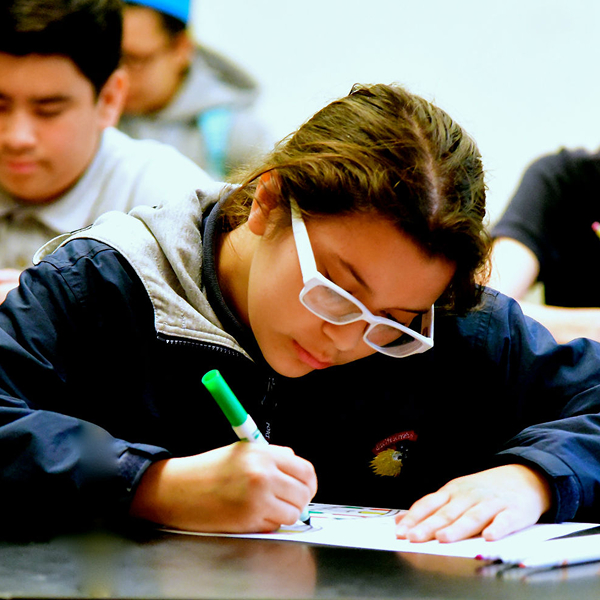 A student works at a desk.
